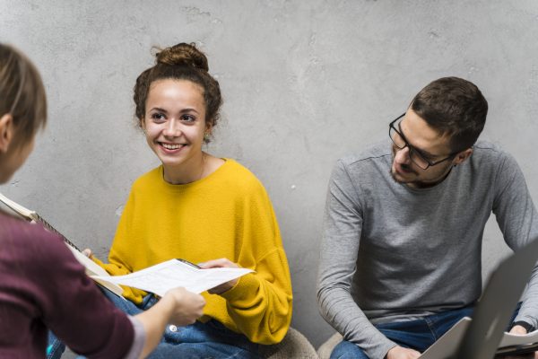 close-up-smiley-people-studying-together-indoors