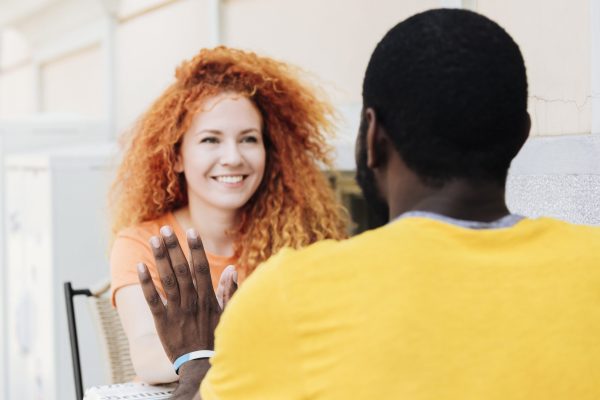 woman-smiling-holding-hands-with-her-lover